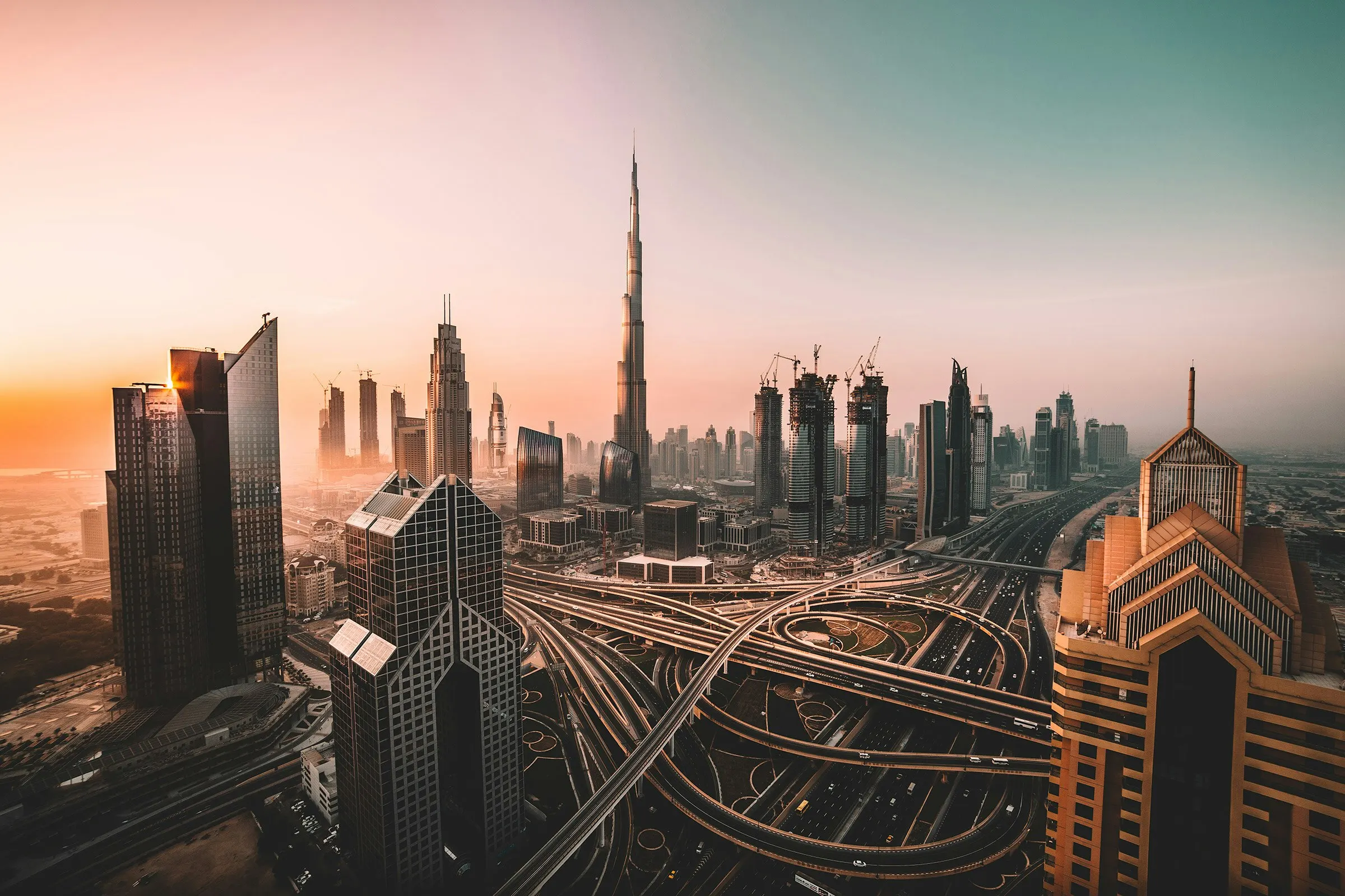 The Dubai skyline at sunset, looking along Sheikh Zayed Road towards Burj Khalifa